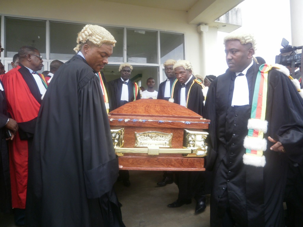 Colleagues take out the casket of Justice Mwambo from the Buea Hospital Mortuary