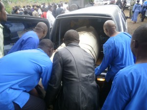 Catholic Men Association members put the casket of Ewunkem in to the hearse after funeral mass