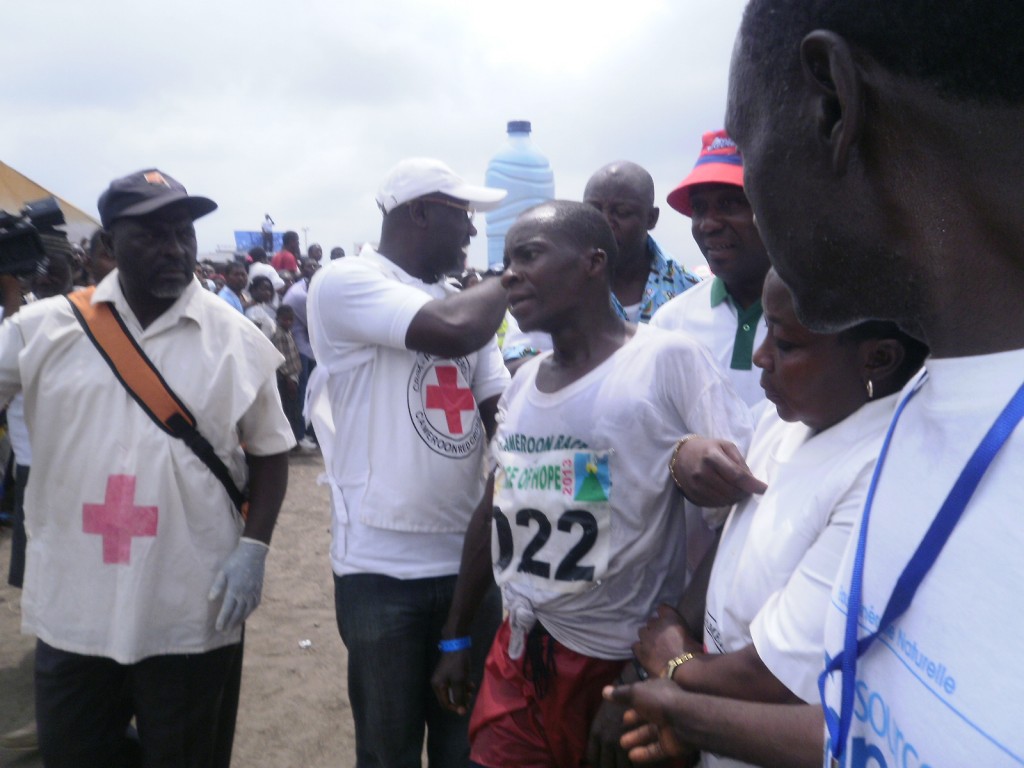 Godlove Gabsibuin, received by Red Cross officials after crossing the finish line in the Molyko Stadium