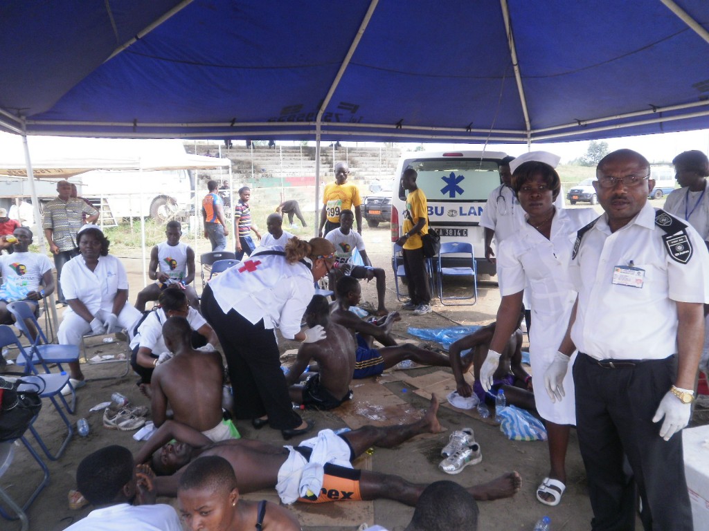 Medical officials take care of the athletes after they have crossed the finished line