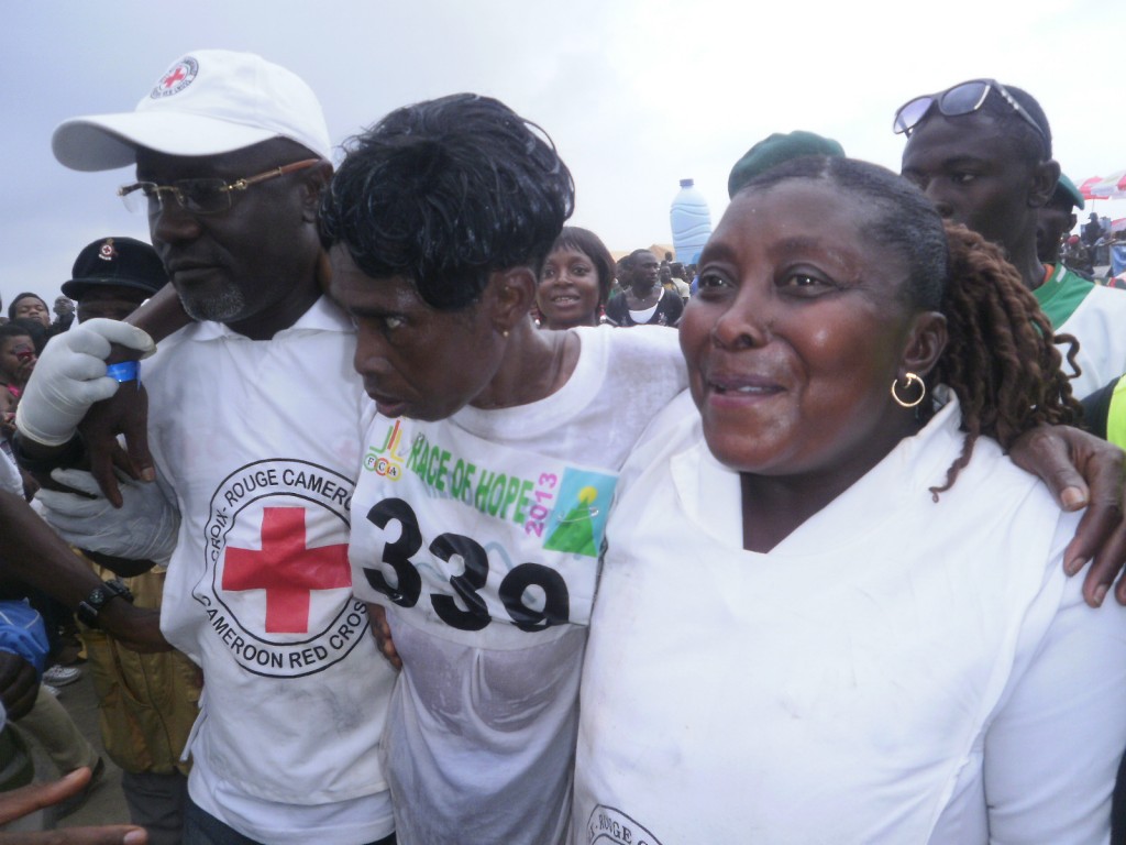 Sarah Liengu Etongue helped by Red Cross Officials after crossing the finish line in the second position, female category