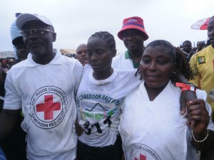 Yvonne Ngwaya in the arms of Red Cross officials after crossing the finish line