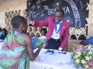 Limbe Rotary Club President, Ngale encourages a student of GS Bomaka during cultural display