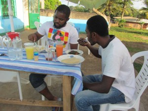 Mac, a customer and friend eating fufu and eru